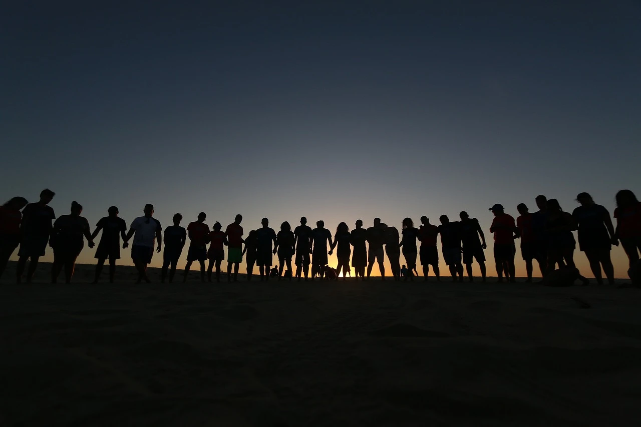 Large backlit group of people in line